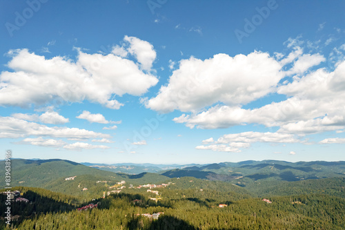 Moving white clouds blue sky scenic aerial view through summer. Drone slide turn flies forward high in blue sky through fluffy clouds on the panorama