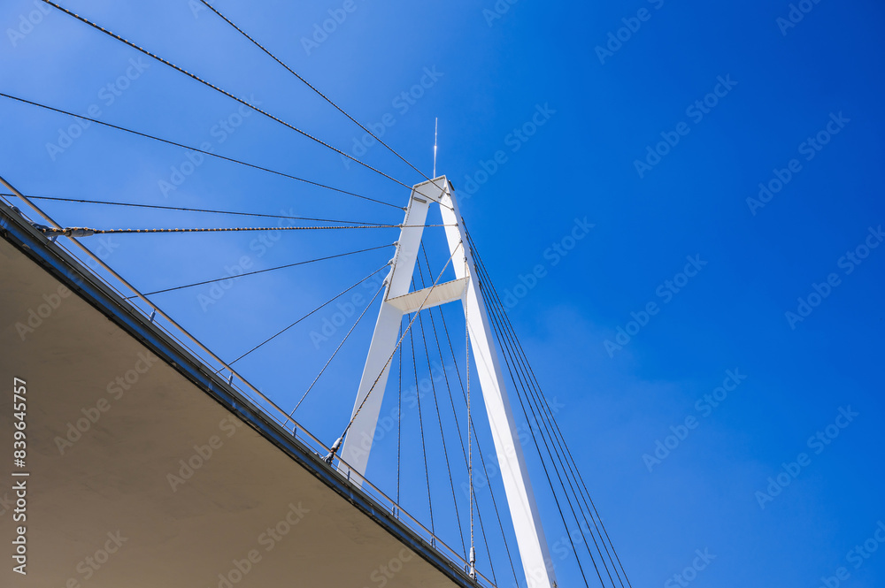 construction of a modern cable-stayed bridge on background of blue sky in Anhor Park in Tashkent in Uzbekistan. New pedestrian suspension bridge construction of a modern cable-stayed bridge on background of blue sky in Anhor Park in Tashkent in Uzbekistan. New pedestrian suspension bridge