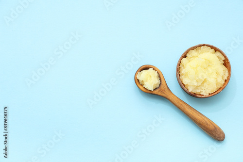 Wooden bowl and spoon with natural body scrub on color background © Pixel-Shot