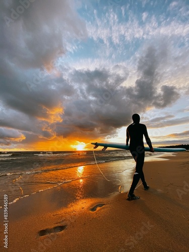 surfing sportsmen try to catch waves in the baltic sea finnish bay at sunset and wetsuits, cool fresh sea