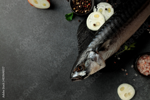 Dried mackerel herring on a black cutting board on a black background photo