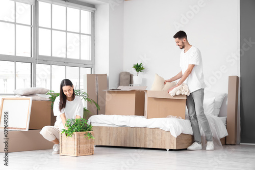 Young couple with boxes in ...