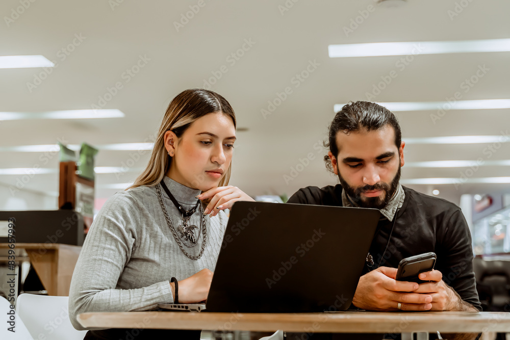 Team working on their laptop in a coworker. Self-employed entrepreneurs. Economic independence. Analysis and results. Team working on their laptop in a coworker. Self-employed entrepreneurs. Economic independence. Analysis and results.