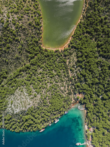 Drone view of evergreen forest, green water lake and blue sea in Dugi Otok island, Telascica National Park, Croatia photo