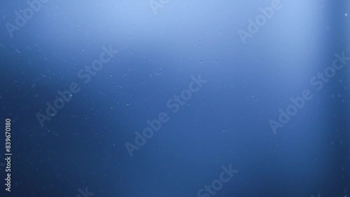 Rain drops on window glasses surface. Natural Pattern of raindrops on clear window.