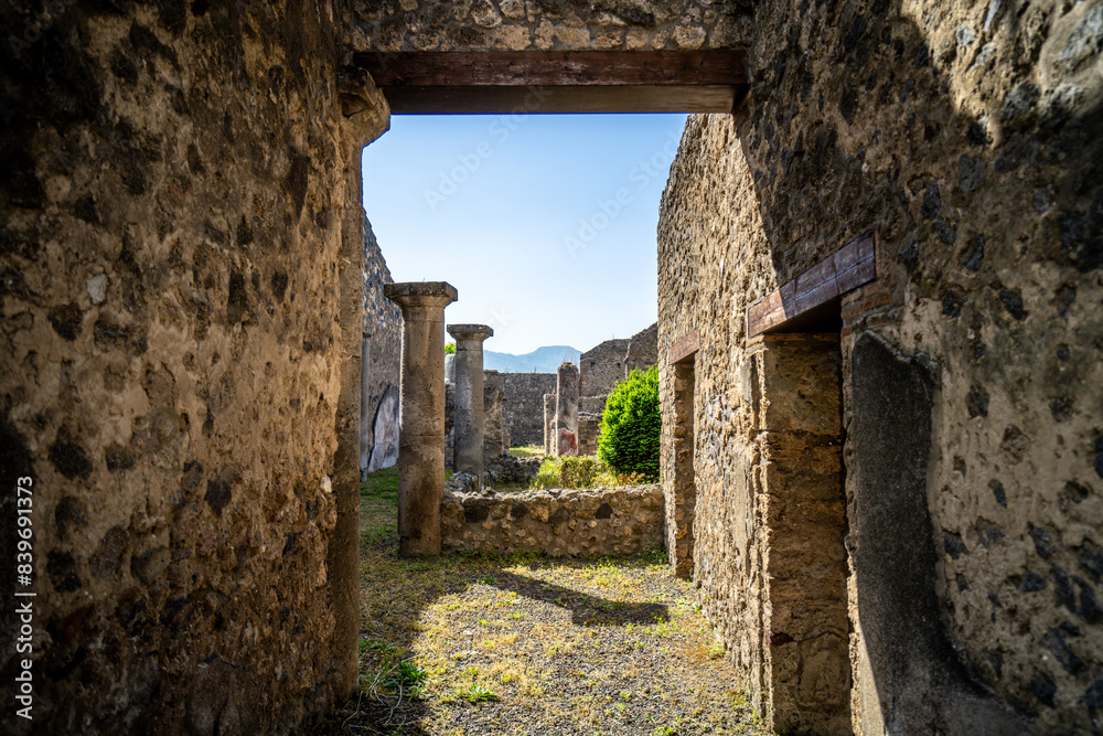 Ruins of ancient city of Pompeii, ancient roman city against Vesuvius volcano at sunset, Italy