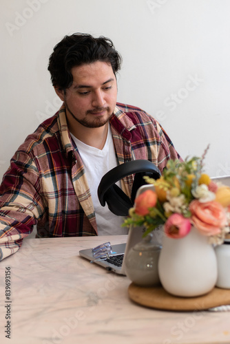 Young man making video call in the living room with happiness