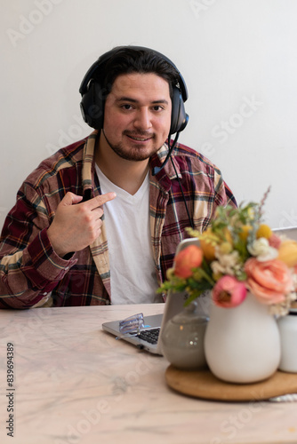 Man using headset and preparing to play and get fun with his laptop in the living room