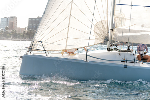 Competitive sailing boat gliding on sunny day