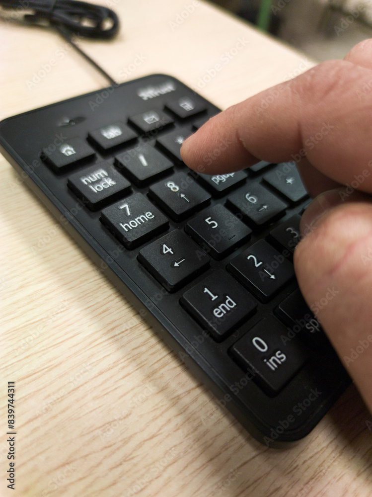 Mature mans hand pressing a numeric keypad Mature mans hand pressing a numeric keypad