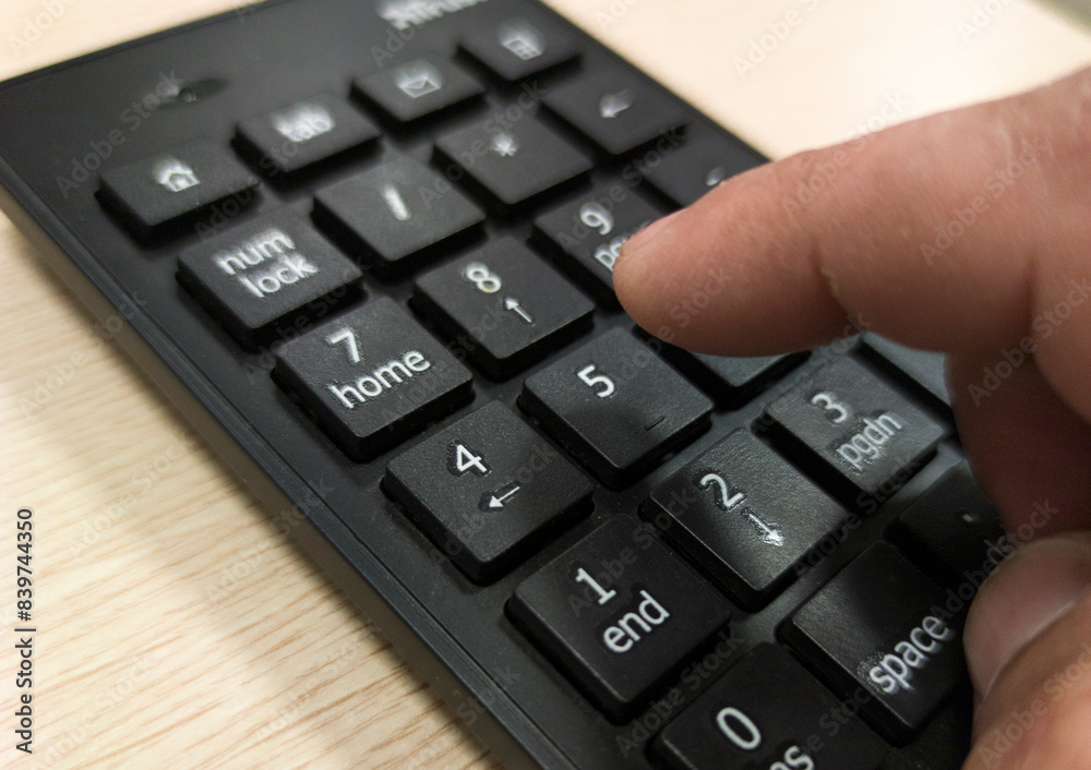 Mature mans hand pressing a numeric keypad Mature mans hand pressing a numeric keypad