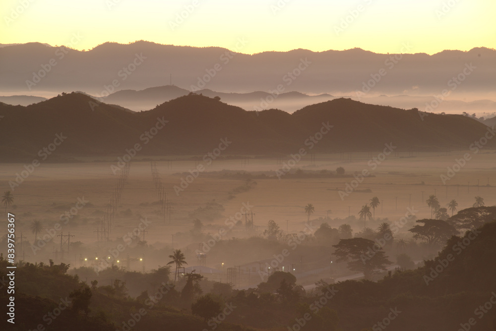 Obraz premium Evening view on top of the mountain at Rattanabun Chedi view point and gentle light In the valley there was a long mist. Located at Mrauk-U city, Myanmar.