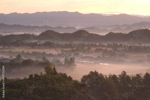 Evening view on top of the mountain at Rattanabun Chedi view point and gentle light In the valley there was a long mist. Located at Mrauk-U city, Myanmar.