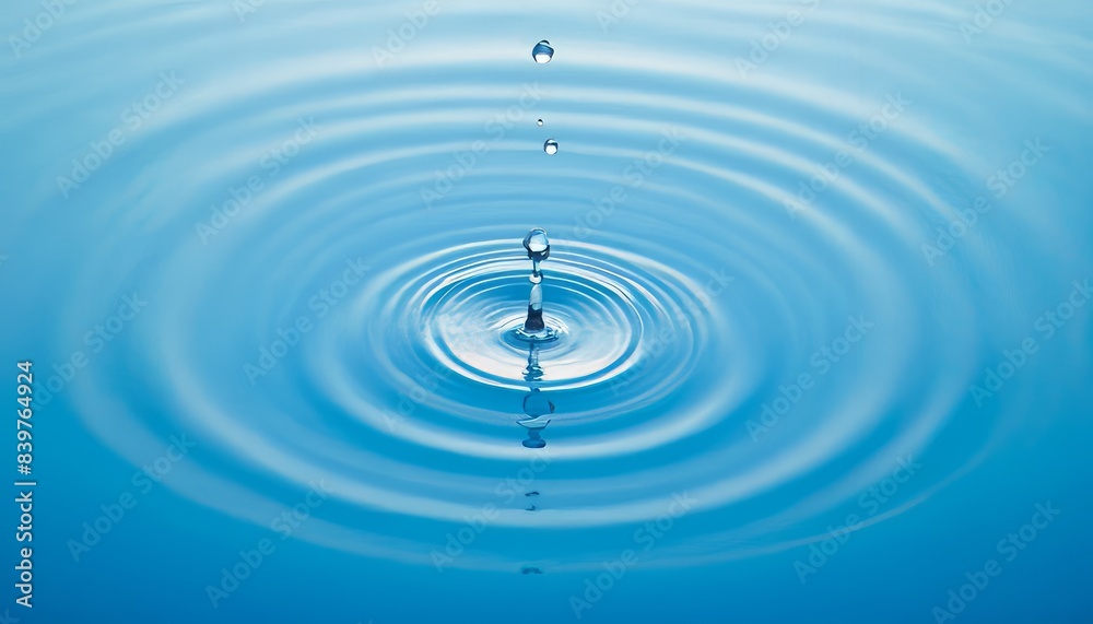 Close-up of a falling drop of water creating circular waves on the calm surface of the water. The concept of purity, tranquility and harmony of nature Close-up of a falling drop of water creating circular waves on the calm surface of the water. The concept of purity, tranquility and harmony of nature