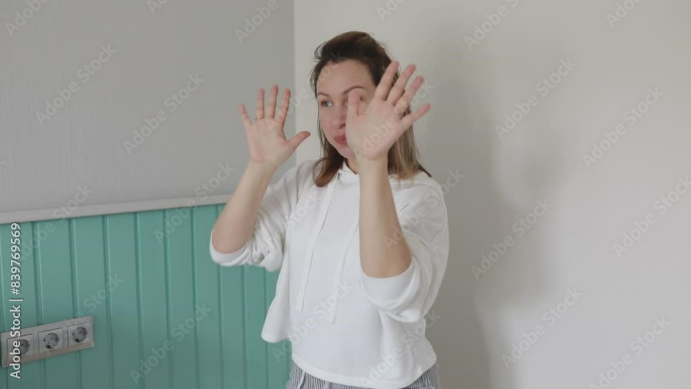 Woman Demonstrating Simple Dance Moves In Casual Home Environment During Daytime Woman Demonstrating Simple Dance Moves In Casual Home Environment During Daytime