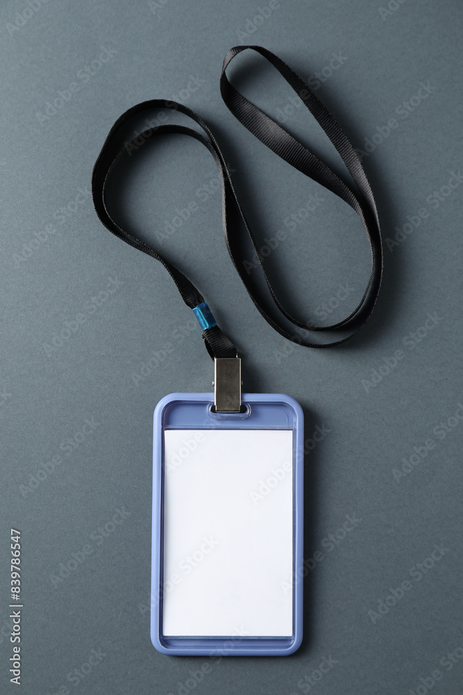 Blank badge with string on grey background, top view