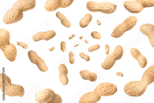 Unpeeled peanuts in air on white background