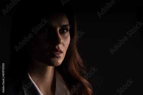 A close up of a woman s face in the dark