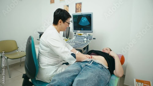 The doctor palpates the organs of the abdominal cavity in the medical office. Care of internal organs in a medical institution. High quality 4k footage