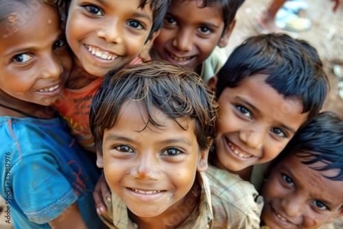 Group of indian kids smiling at the camera in a village. © Igor