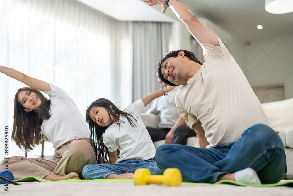 Portrait of happy love asian fit strength family mother with little asian girl training sitting relax and practicing yoga, fitness, exercise, wellness, workout, sport at home.Diet.Fitness, healthy Portrait of happy love asian fit strength family mother with little asian girl training sitting relax and practicing yoga, fitness, exercise, wellness, workout, sport at home.Diet.Fitness, healthy