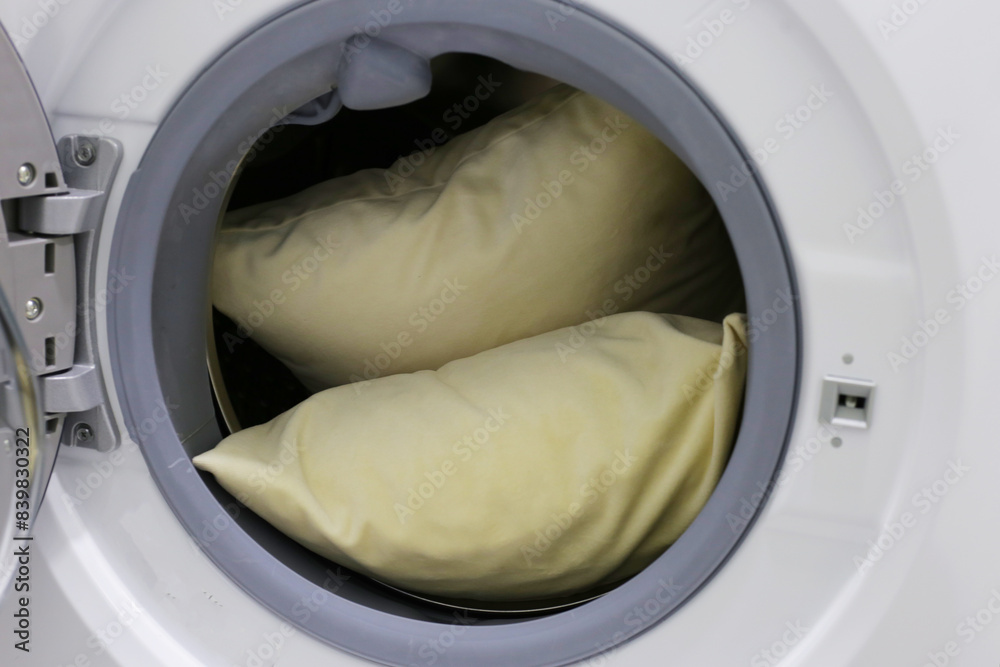 White pillow in washing machine.