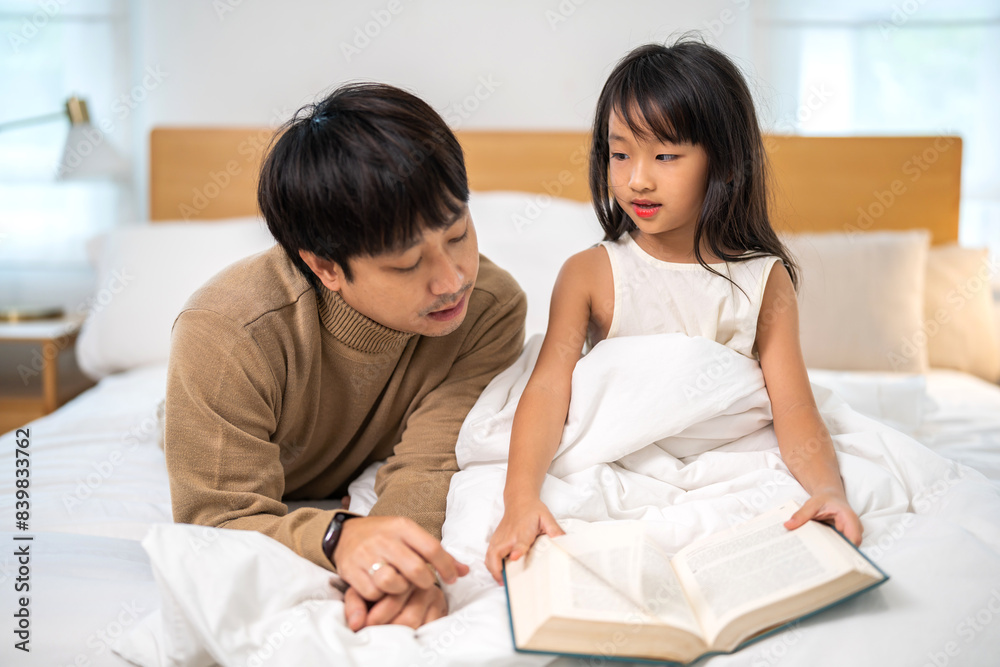 Portrait happy love asian family father teach little daughter asian girl learn and study on table.dad and asian young girl read book making lessons in homeschool at home.Education Portrait happy love asian family father teach little daughter asian girl learn and study on table.dad and asian young girl read book making lessons in homeschool at home.Education