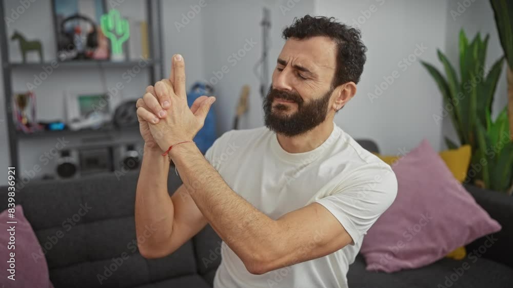 Angry middle-age man at home, boldly playing the symbol of a shooting game, wielding his hand as a symbolic gun. holding an imaginary weapon in his confident grip, his face set in a serious scowl. Angry middle-age man at home, boldly playing the symbol of a shooting game, wielding his hand as a symbolic gun. holding an imaginary weapon in his confident grip, his face set in a serious scowl.