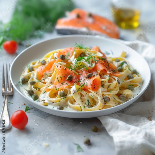 a gourmet feast, a pasta dish featuring al dente fettucine infused with creamy sauce, loaded with a generous amount of smoked salmon, garnished with capers and coriander