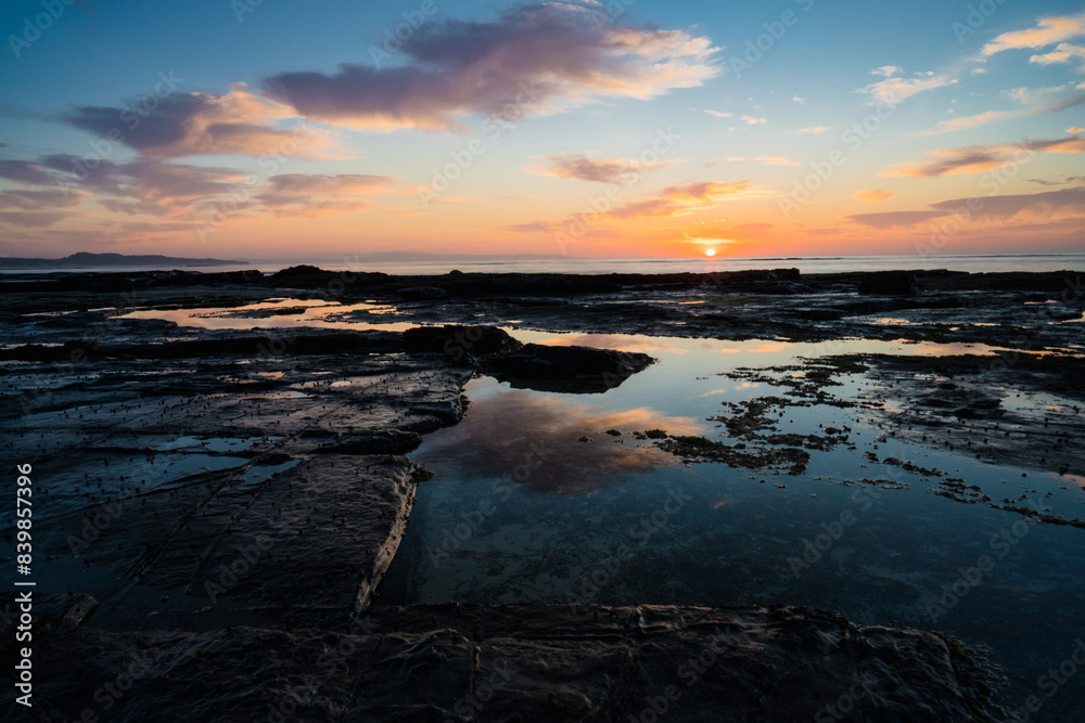 sunrise over the rocks on the coast sunrise over the rocks on the coast