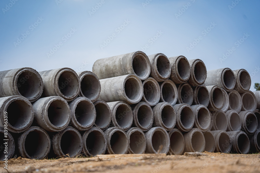 A stack of concrete ring pipes piled and creating a symmetrical arrangement A stack of concrete ring pipes piled and creating a symmetrical arrangement