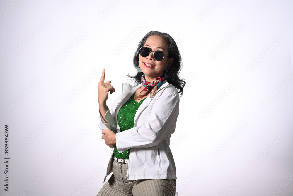 Photo of pretty middle age woman in sunglasses posing isolated over white background Photo of pretty middle age woman in sunglasses posing isolated over white background