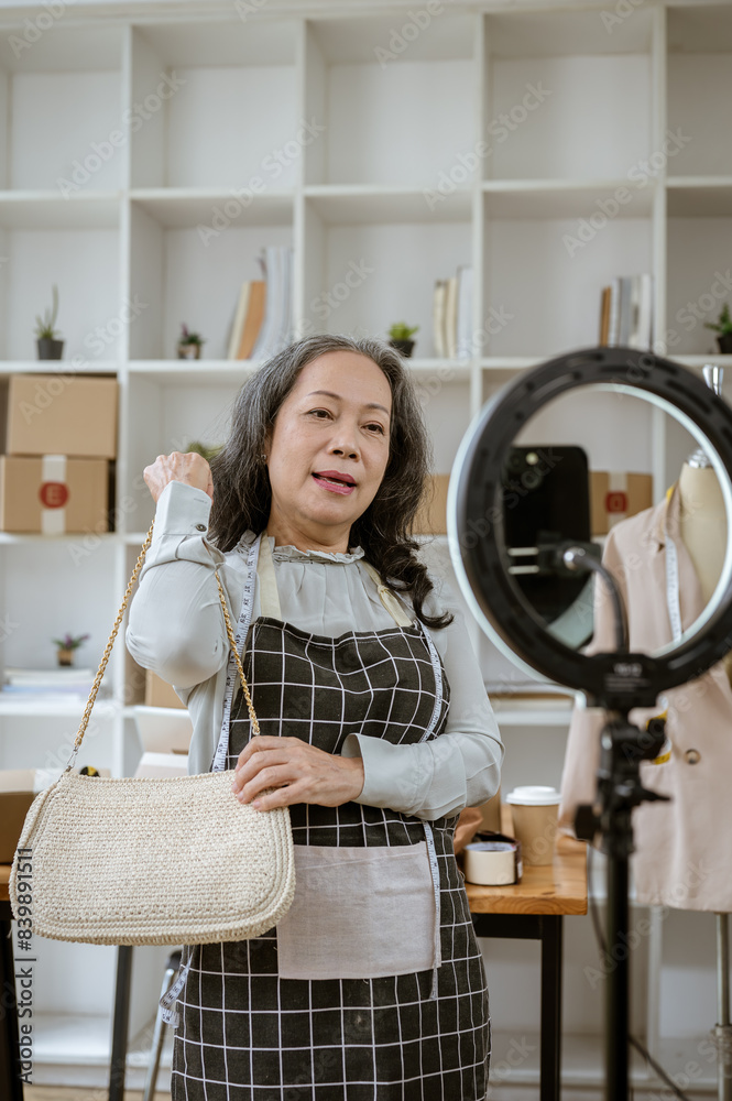 A female online seller is showing her goods through a camera, selling her products online via live. A female online seller is showing her goods through a camera, selling her products online via live.