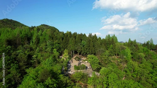 Drone flying towards Helong Park amidst lush greenery in Tianzi Mountain, Wulingyuan. Zhangjiajie, China photo