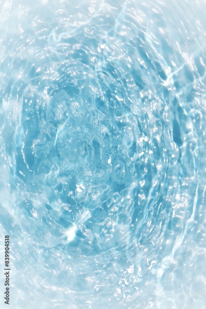 Blue water with ripples on the surface. Defocus blurred transparent blue colored clear calm water surface texture with splashes and bubbles. Water waves with shining pattern texture background. Blue water with ripples on the surface. Defocus blurred transparent blue colored clear calm water surface texture with splashes and bubbles. Water waves with shining pattern texture background.
