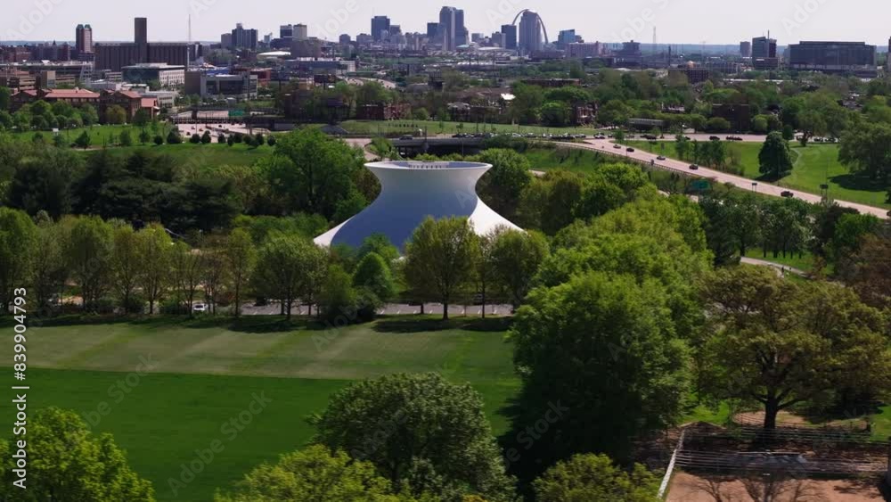 Highangle view of James S. McDonnell Planetarium and its unique structure, and the St Louis skyline in the background, transitioning through the landscape Highangle view of James S. McDonnell Planetarium and its unique structure, and the St Louis skyline in the background, transitioning through the landscape