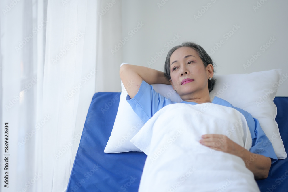 Elderly woman resting in a hospital bed, looking thoughtful. Patient in medical care. Bright and serene hospital room. Elderly woman resting in a hospital bed, looking thoughtful. Patient in medical care. Bright and serene hospital room.
