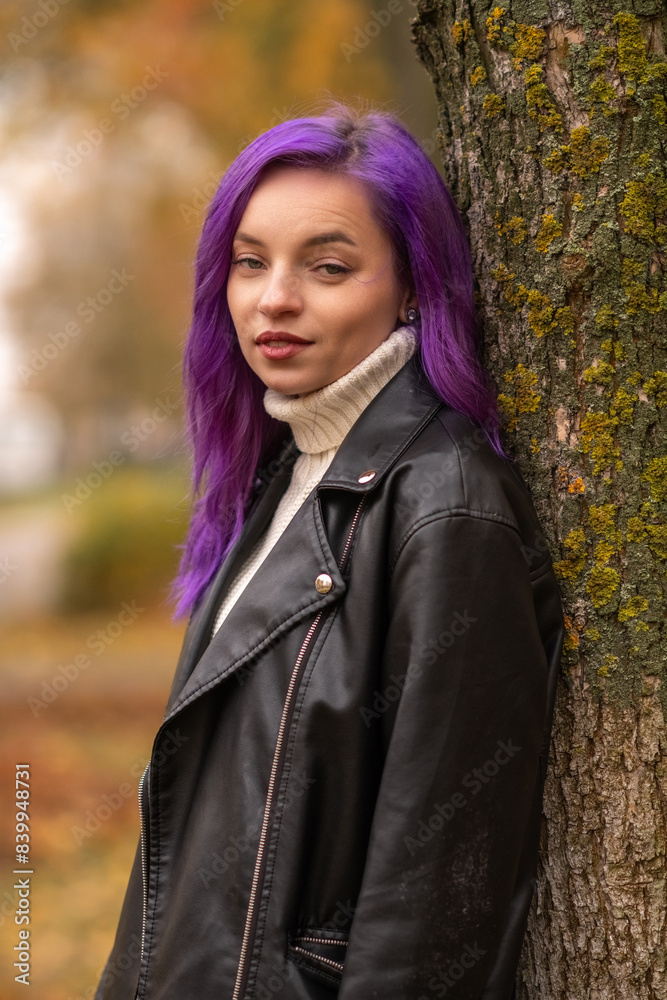 Portrait of a young beautiful girl with purple hair in the autumn city. Portrait of a young beautiful girl with purple hair in the autumn city.