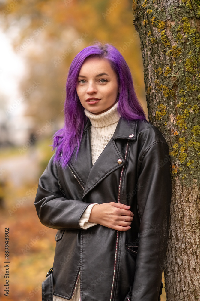 Portrait of a young beautiful girl with purple hair in the autumn city. Portrait of a young beautiful girl with purple hair in the autumn city.