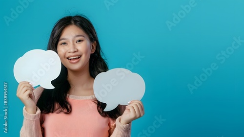 A woman is holding two white paper balloons and smiling © Moon Story