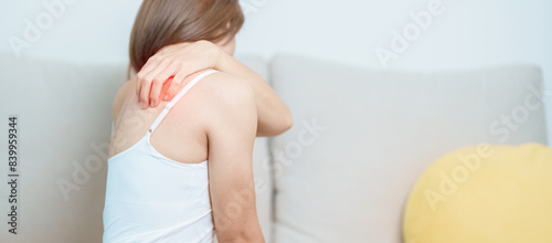 Woman having Shoulder and Neck pain at home. Muscle painful due to Myofascial pain syndrome and Fibromyalgia, rheumatism, Scapular pain, Cervical Spine. ergonomic concept photo