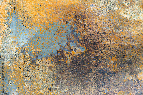 Rusty metal surface with weathered texture in orange, brown, and blue tones, ideal for industrial, grunge, or abstract backgrounds