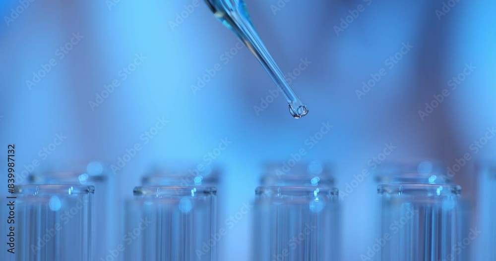 Drop of liquid from pipette into test tube in laboratory Drop of liquid from pipette into test tube in laboratory
