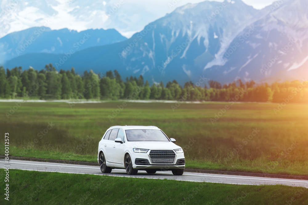 Fototapeta premium Luxury white SUV explores scenic route