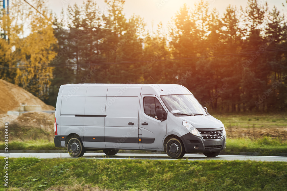 White delivery van speeding along a country road White delivery van speeding along a country road