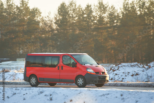 Van speeding along a scenic rural road