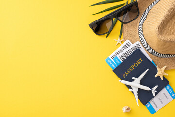 Travel essentials including a passport, boarding passes, sunglasses, and a hat arranged on a yellow background reflecting a summer vacation vibe
