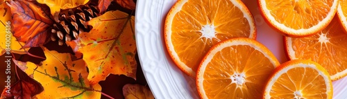 Bright orange slices of duhat fruit arranged neatly on a white plate, with a backdrop of autumn foliage photo