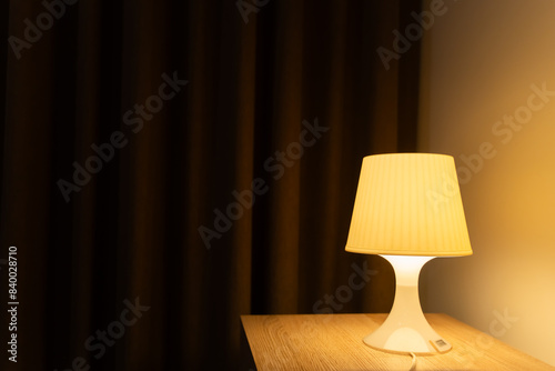 Lamp on table of bedside, Interior of the bedroom, warm light for background.