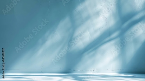 abstract light blue background for product presentation. Shadow and light from windows on plaster wall.